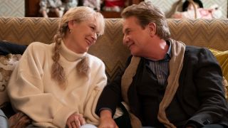 Meryl Streep and Martin Short sitting together looking into each others eyes and smiling. 