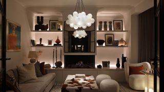 living room with layered lighting scheme and feature chandelier