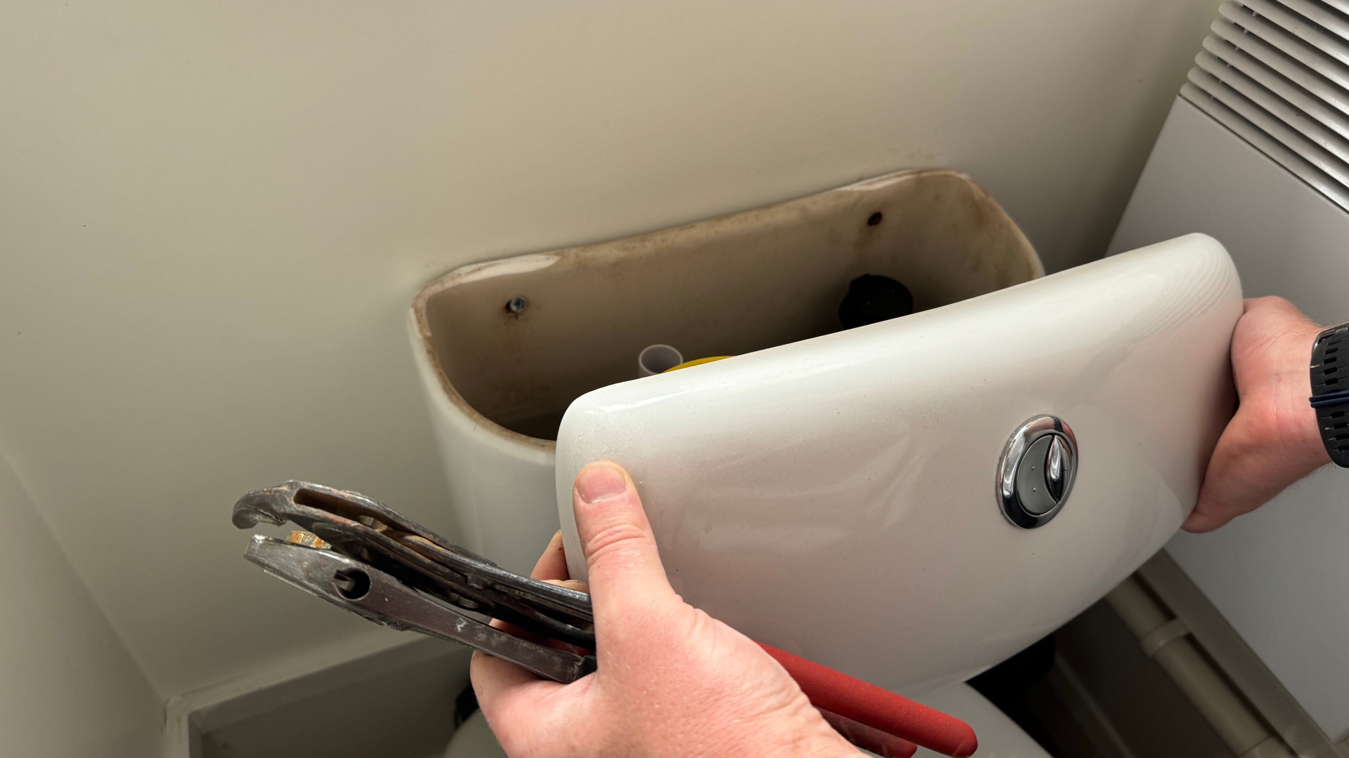 Checking the tank on a toilet