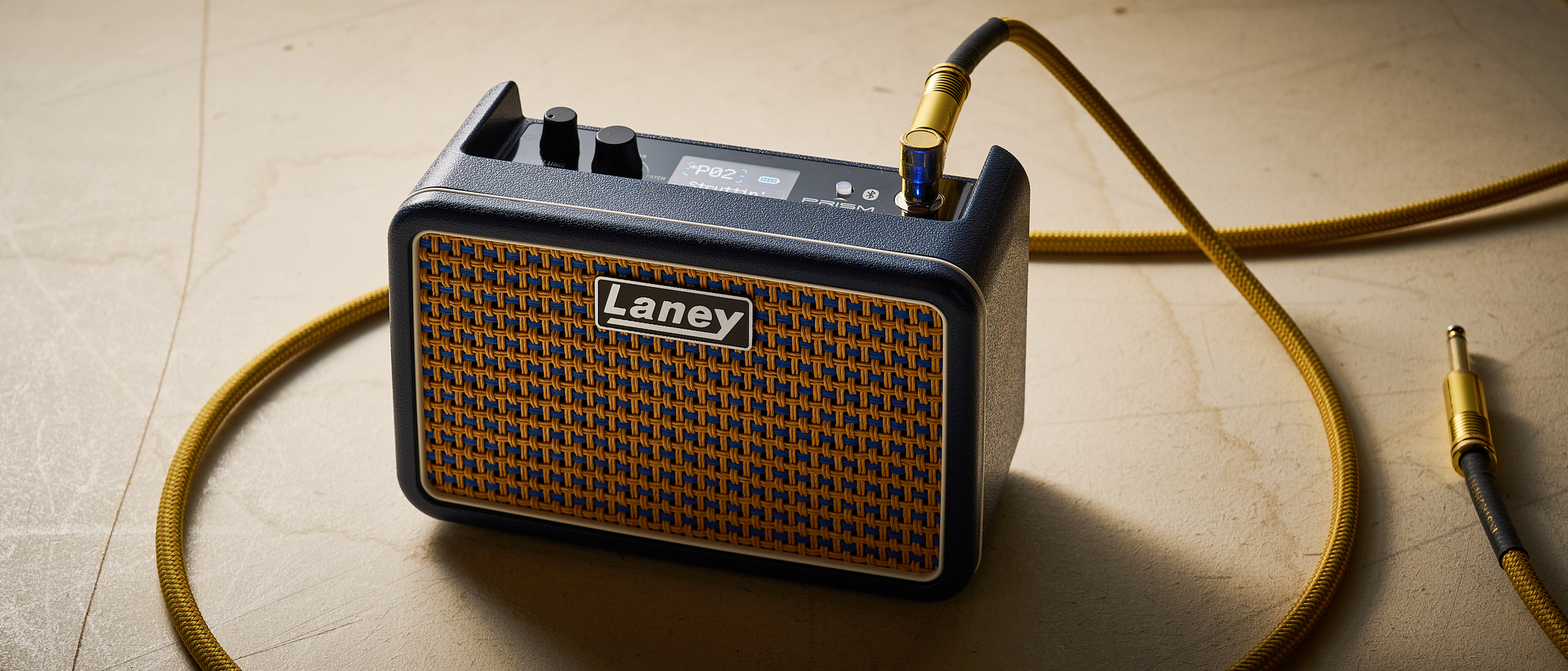 A Laney Prism Mini amp with a guitar cable plugged into it