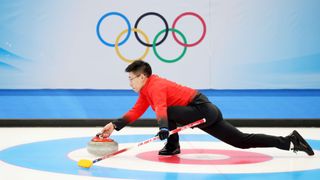 A curler in action at the Winter Olympics