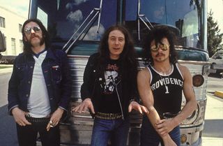 Motorhead standing in from of their tour bus