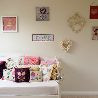 bedroom with display area and cushion collection