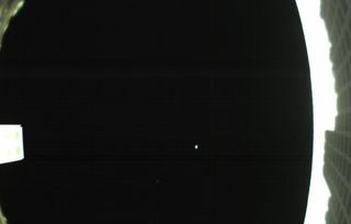 The first photo captured by one of NASA's two Mars Cube One (MarCO) cubesats, which launched along with the agency's InSight lander on May 5, 2018. The image, which shows the cubesat's unfolded high-gain antenna at right and Earth and the moon in the center, was acquired by the cubesat, dubbed MarCO-B, on May 9.