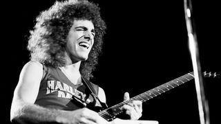 Neal Schon, of the group Journey, plays electric guitar as he performs onstage at Utica Memorial Auditorium (later known as the Adirondack Bank Center at the Utica Memorial Auditorium), Utica, New York, May 6, 1980.