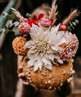 DIY pumpkin vase idea with fresh flowers in a gnarly pumpkin