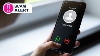 A hand holding a phone showing a call from an unknown number