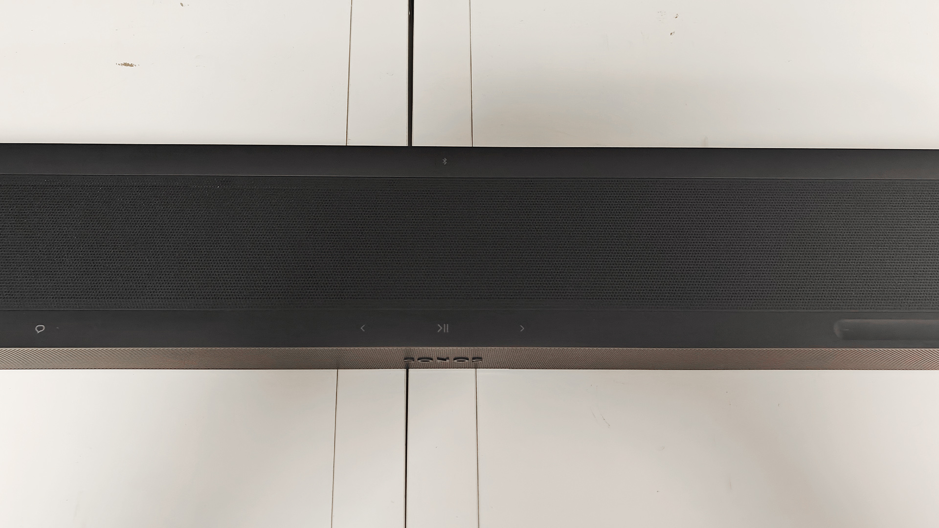Sonos Beam Ultra Dolby Atmos soundbar on white shelving unit viewed from above