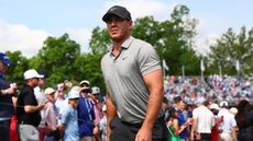 Brooks Koepka walks to a tee at the PGA Championship