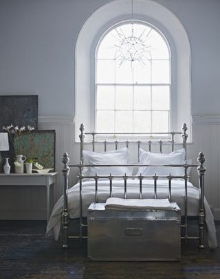 A bed with brass railing