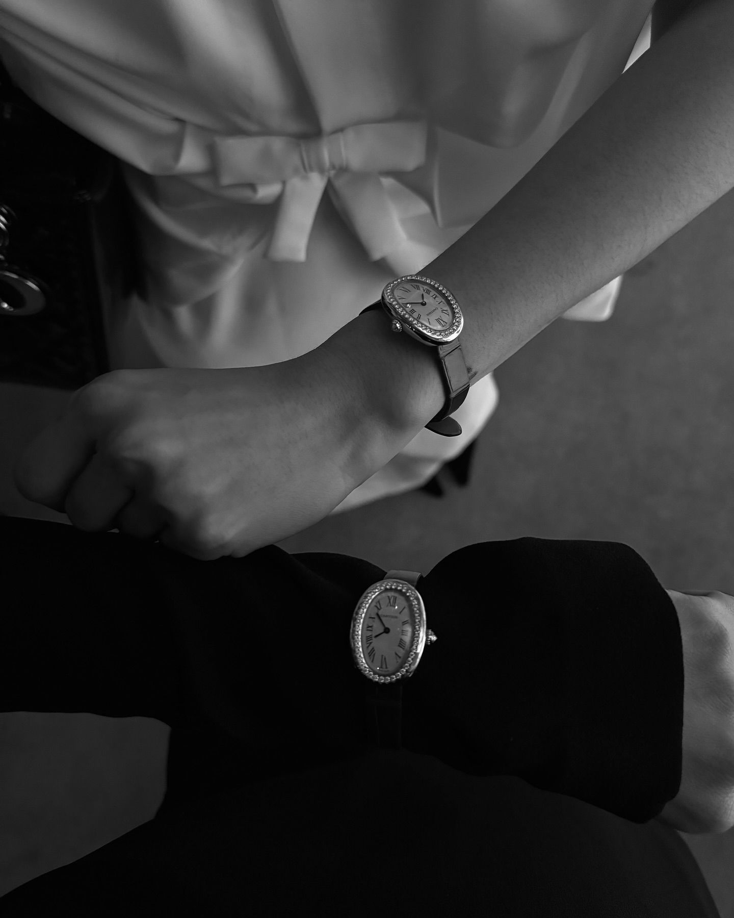 An overhead imager of @annelauremais wearing a Cartier Baignoire on her wrist while posing at a brand event.