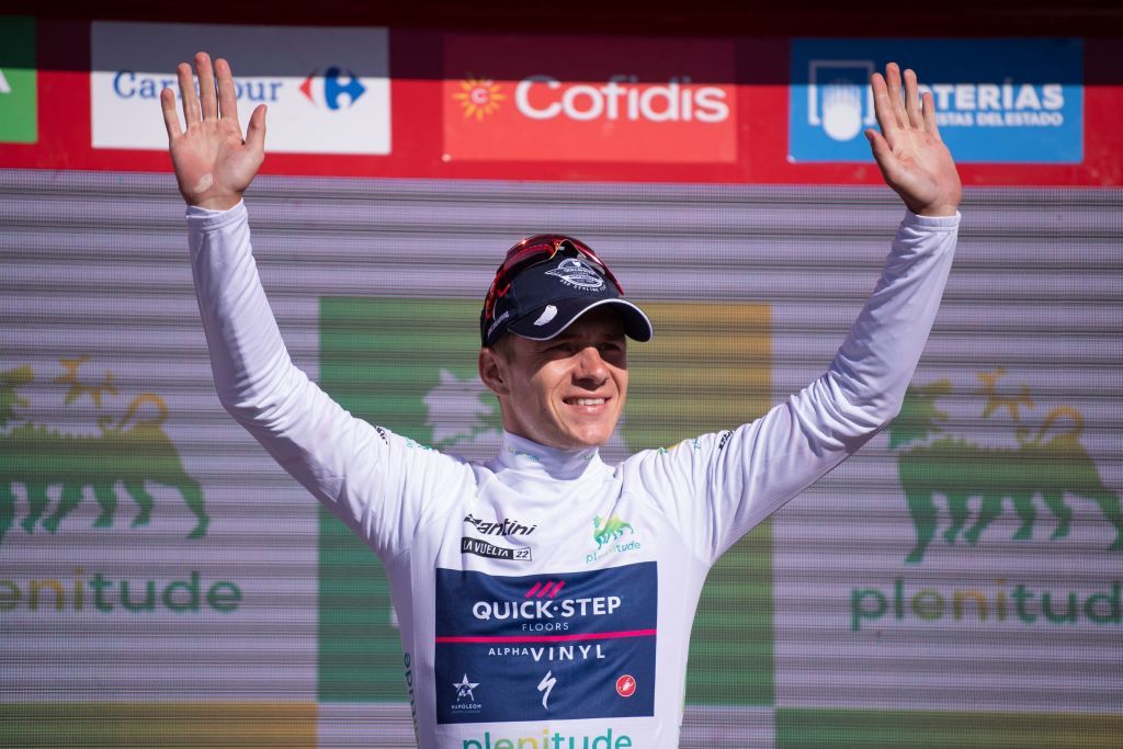 Team Quick Steps Belgian rider Remco Evenepoel celebrates on the podium wearing the best youths white jersey after the 15th stage of the 2022 La Vuelta cycling tour of Spain a 153 km race from Martos to the Alto Hoya de la Mora of the Sierra Nevada in Monachil on September 4 2022 Photo by JORGE GUERRERO AFP Photo by JORGE GUERREROAFP via Getty Images