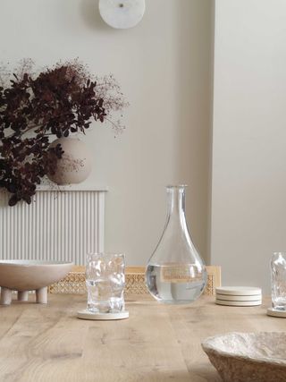 a table with glasses and a decanter on