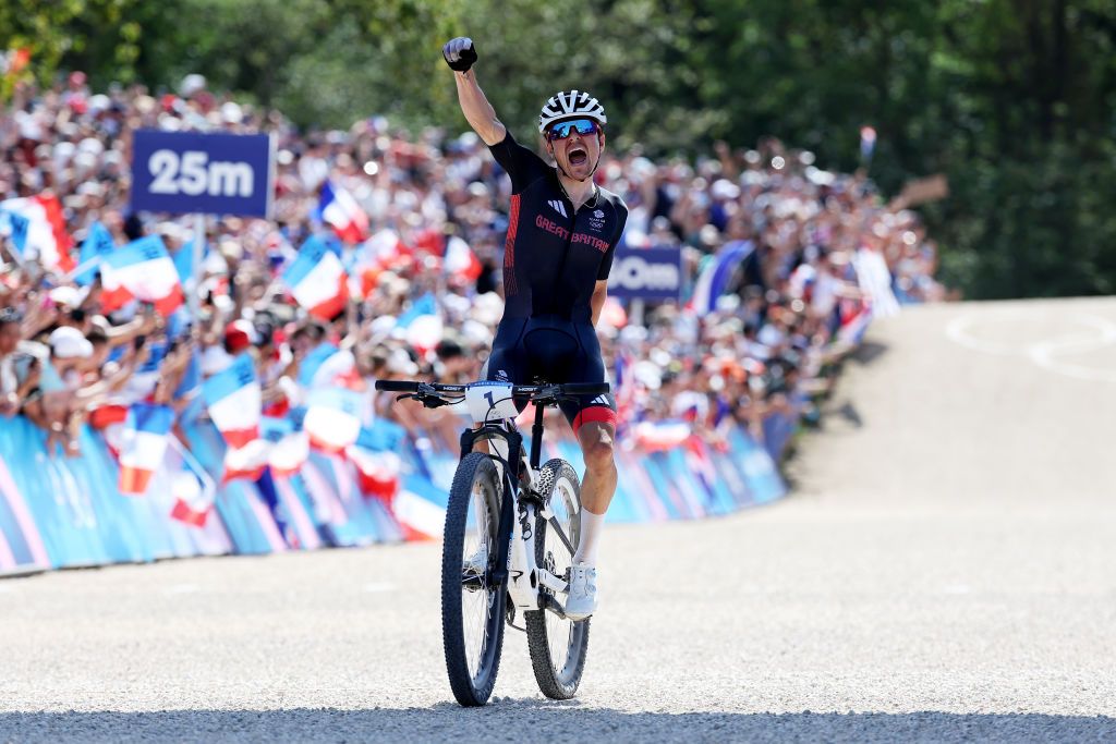 ELANCOURT FRANCE JULY 29 Thomas Pidcock of Team Great Britain celebrates at finish line as gold medal winner during the Mens CrossCountry on day three of the Olympic Games Paris 2024 at Elancourt Hill on July 29 2024 in Elancourt France Photo by Alex BroadwayGetty Images