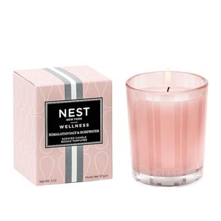 A pink Nest candle next to a pink box
