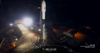 A SpaceX Falcon 9 rocket carrying the first 60 Starlink internet communications satellites stands atop the launchpad at Cape Canaveral Air Force Station, Florida during a May 15, 2019 launch attempt. SpaceX postponed the launch 24 hours due to high winds.