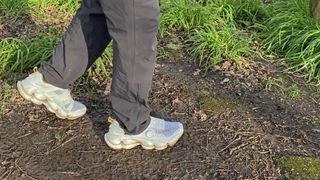 Merrell SpeedArc Surge Boa walking through mud