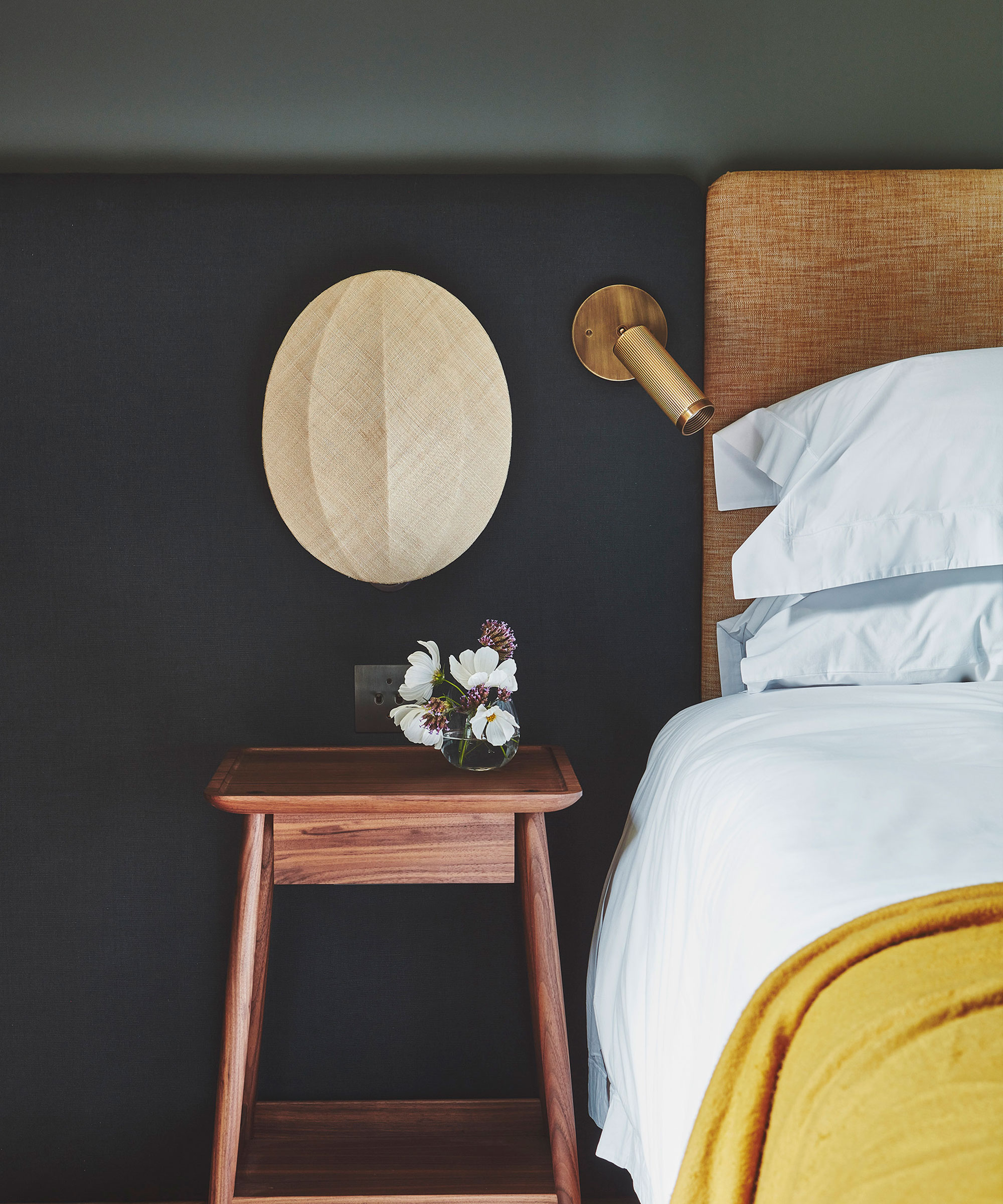 dark blue bedroom with upholstered headboard