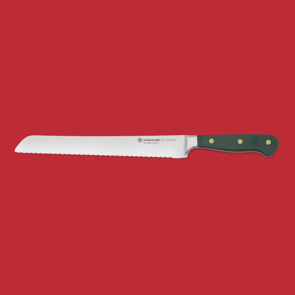 W&amp;uuml;sthof Classic Double Serrated Knife 23cm in green against red background.