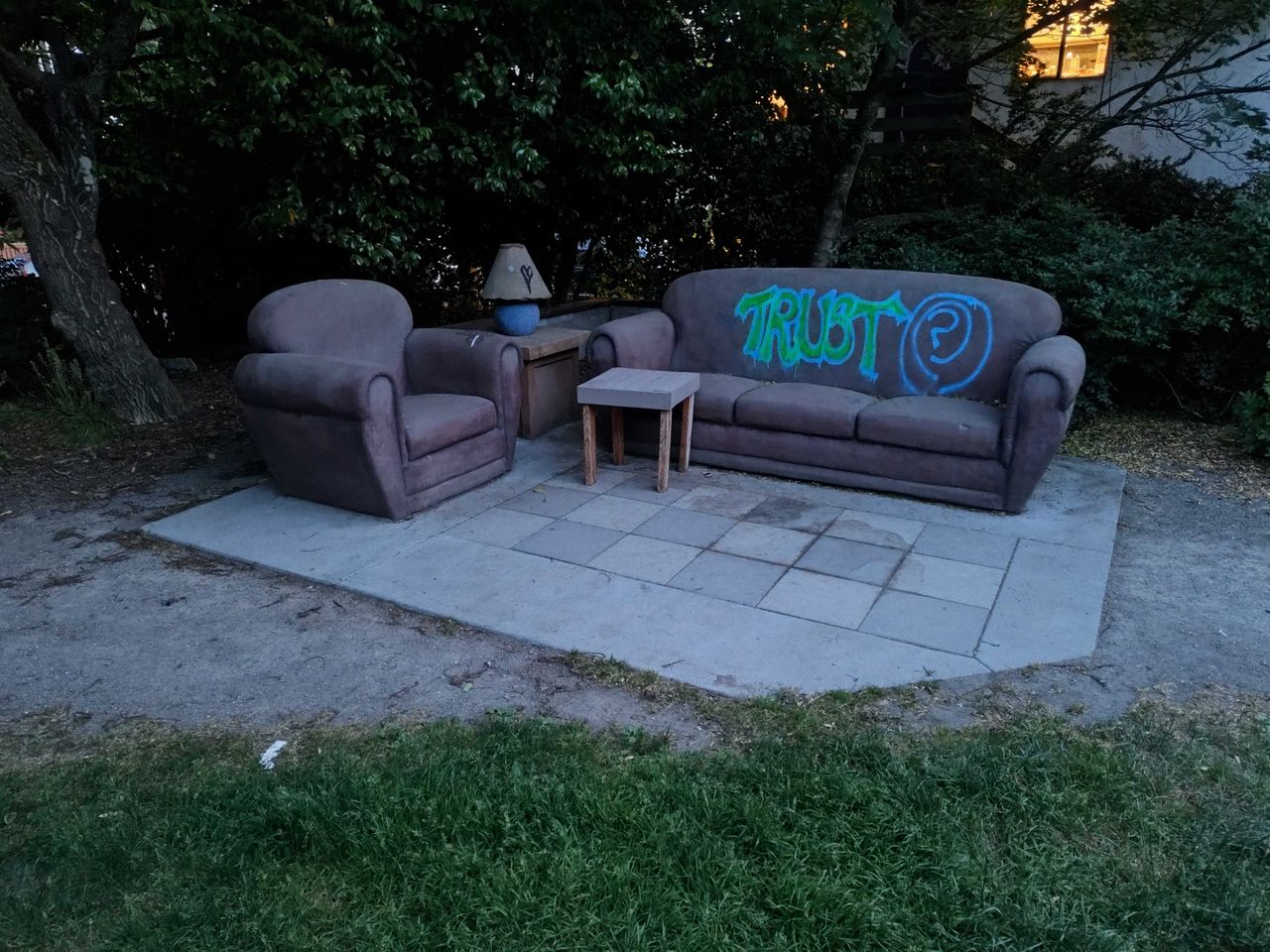 Stone couches at a park in low lighting