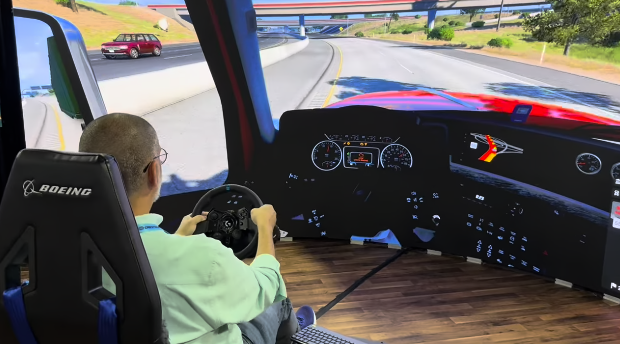 SCN's Wayne Cavadi does a driving simulator at the Vanguard booth at InfoComm 2026. 