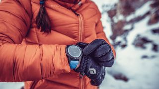 COROS VERTIX review: skier woman looking at smartwatch