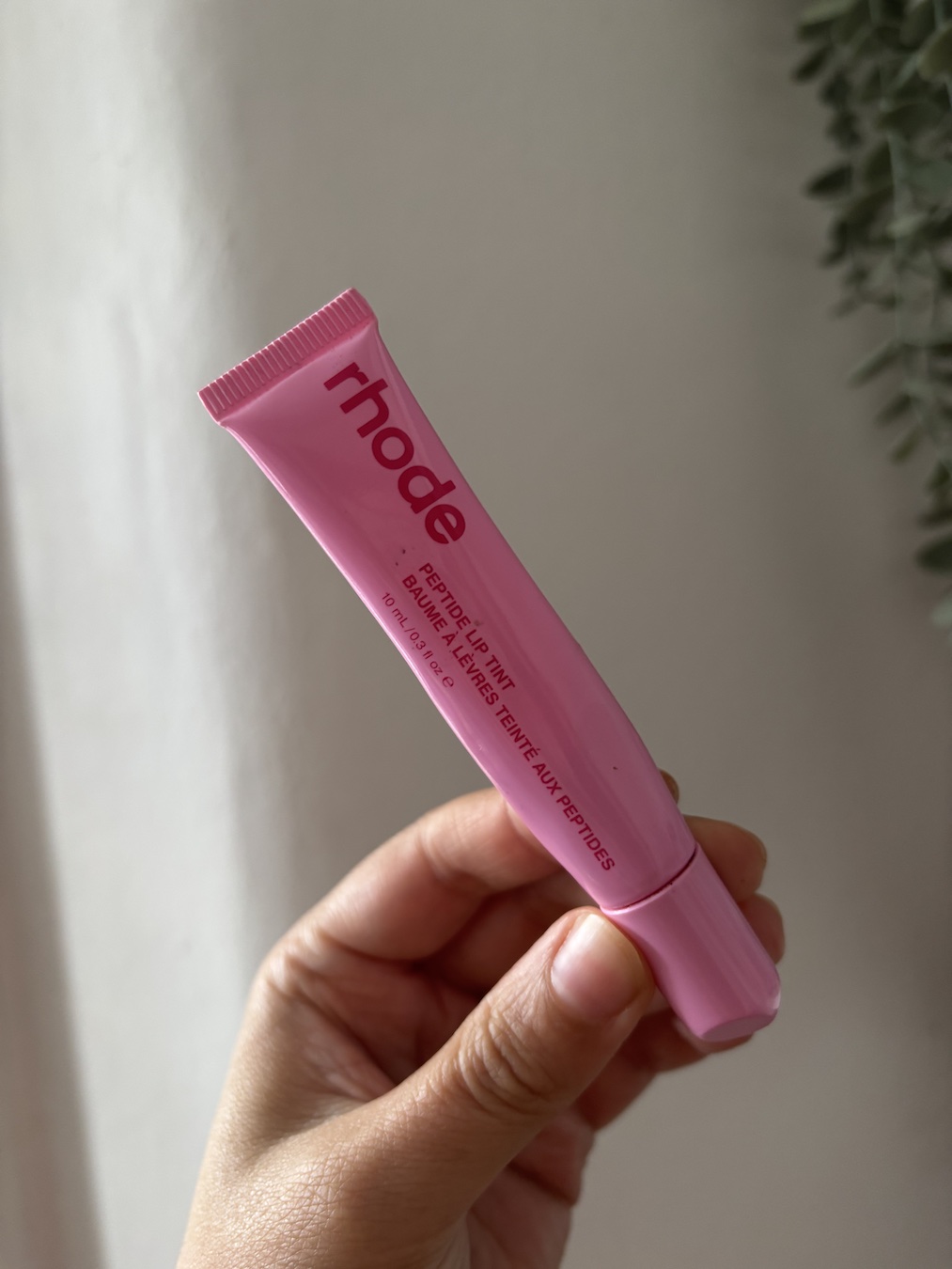 Mica Ricketts holding Rhode Peptide Lip Tint