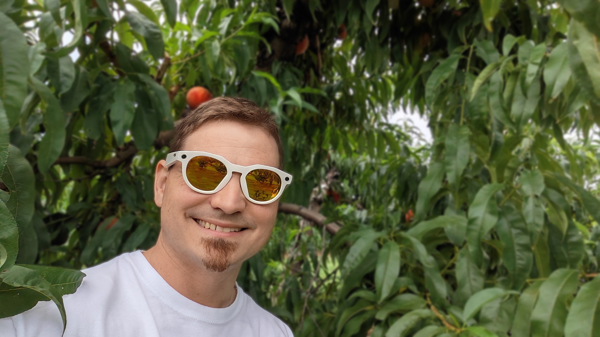 Wearing a pair of limited-edition warm white Meta Oakley HSTN smart glasses with 24K Prizm lenses