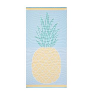 A blue beach towel with a pineapple print