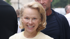 Pamela Anderson wearing butter yellow, sweater and skirt