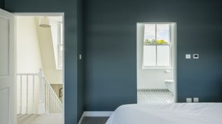 Teal bedroom and white en suite in mansard loft conversion
