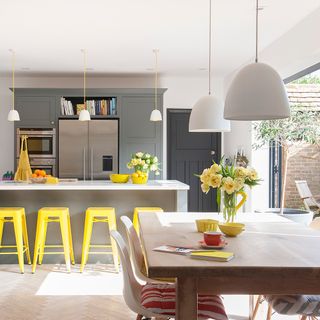kitchen with white wall and counter with yellow stool