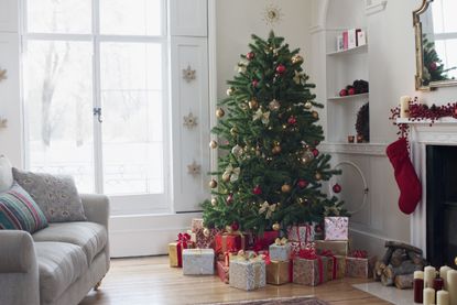 A living room with a Christmas tree decorated with ribbons