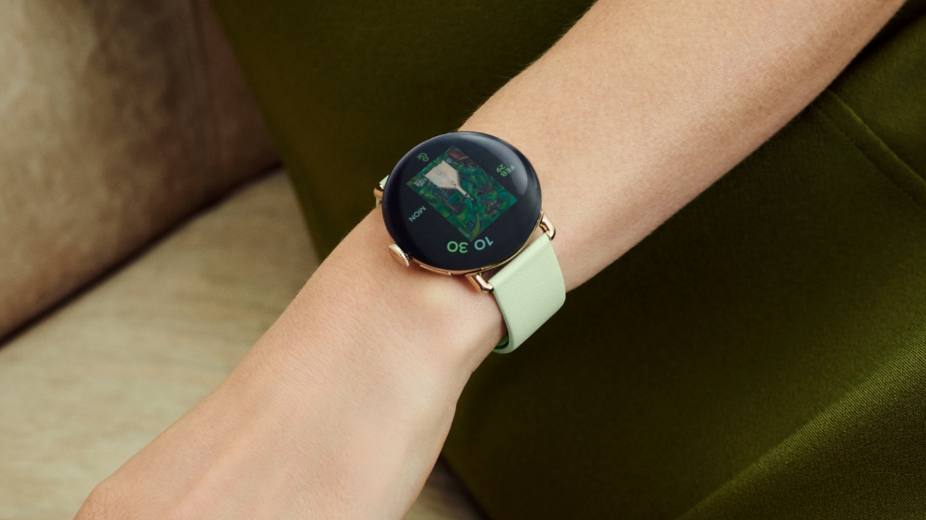 A Google Pixel Watch 4 on a model's wrist with a lemongrass band.