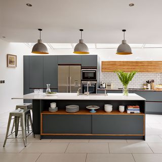 grey kitchen with white tiles and hanging light