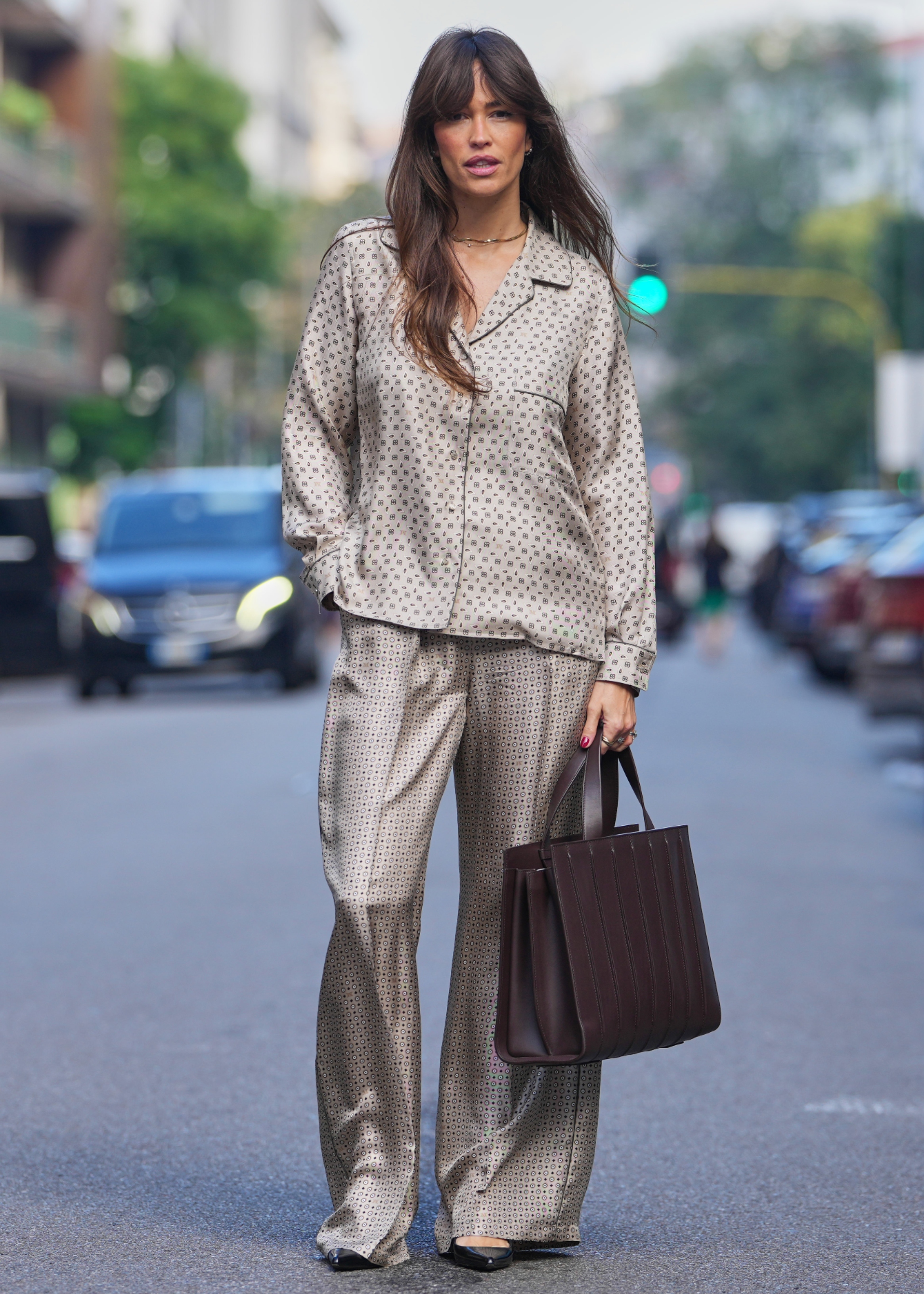 woman wearing a pajama set and a tote bag