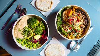 two vegan salad bowls with bread