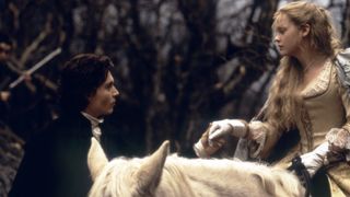 Johnny Depp and Christina Ricci on a horse in the forest in Sleepy Hollow