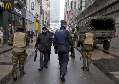 Belgian soldiers and police officers patrol Brussels