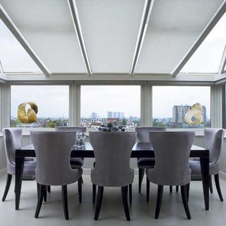 dining room with black dining table and chairs with glass window