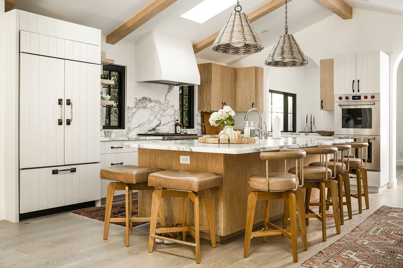 modern famrhouse kitchen with marble island and leather barstools