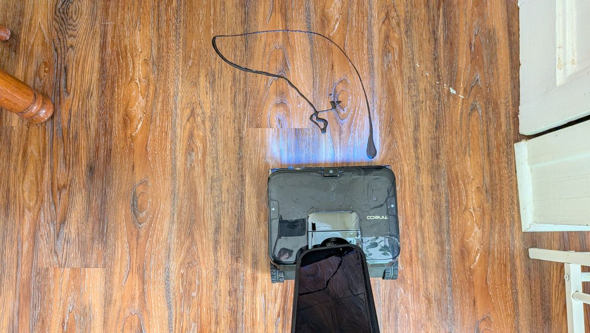 Tineco Floor ONE Station S9 Scientist Pro wet and dry vacuum cleaner about to clean chocolate syrup off hard wood floor