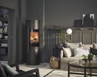 Black living room with cream sofa, carpet and Contura wood burning stove