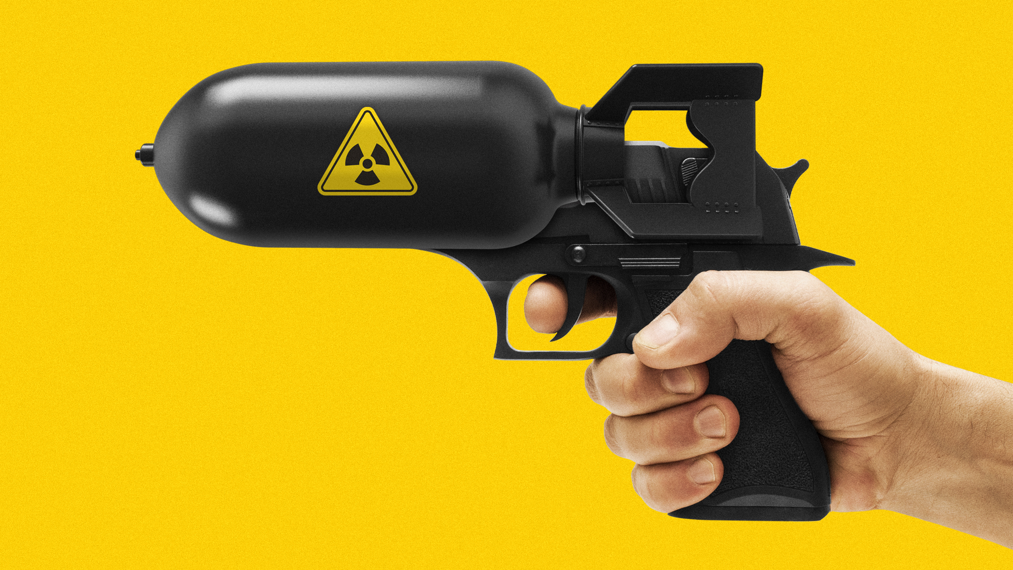 Photo composite illustration of a hand pointing a handgun mounted with a nuclear bomb