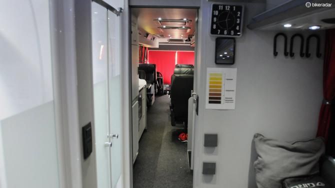The view forwards shows the showers on the left, toilet on the right, storage hooks and essential mirror and clock for looking good when required
