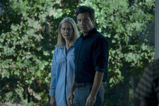 Laura Linney and Jason Bateman standing against a leafy background in Ozark