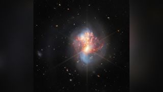 two white galaxies join into one in space