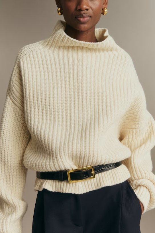 A model wearing a croc-embossed belt with a gold buckle.