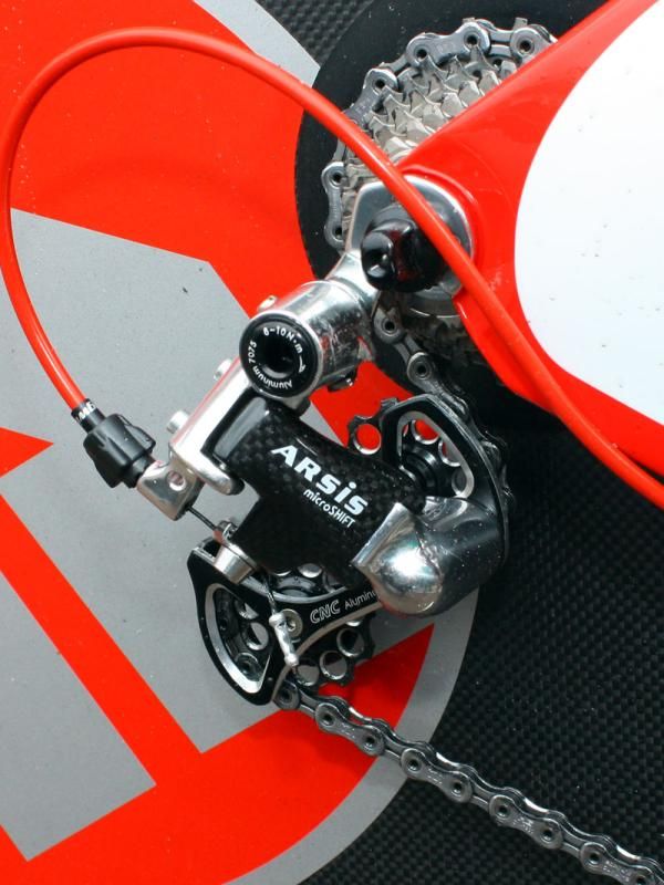 The microSHIFT ARSiS rear derailleur is built with a carbon-wrapped outer plate and cage.
