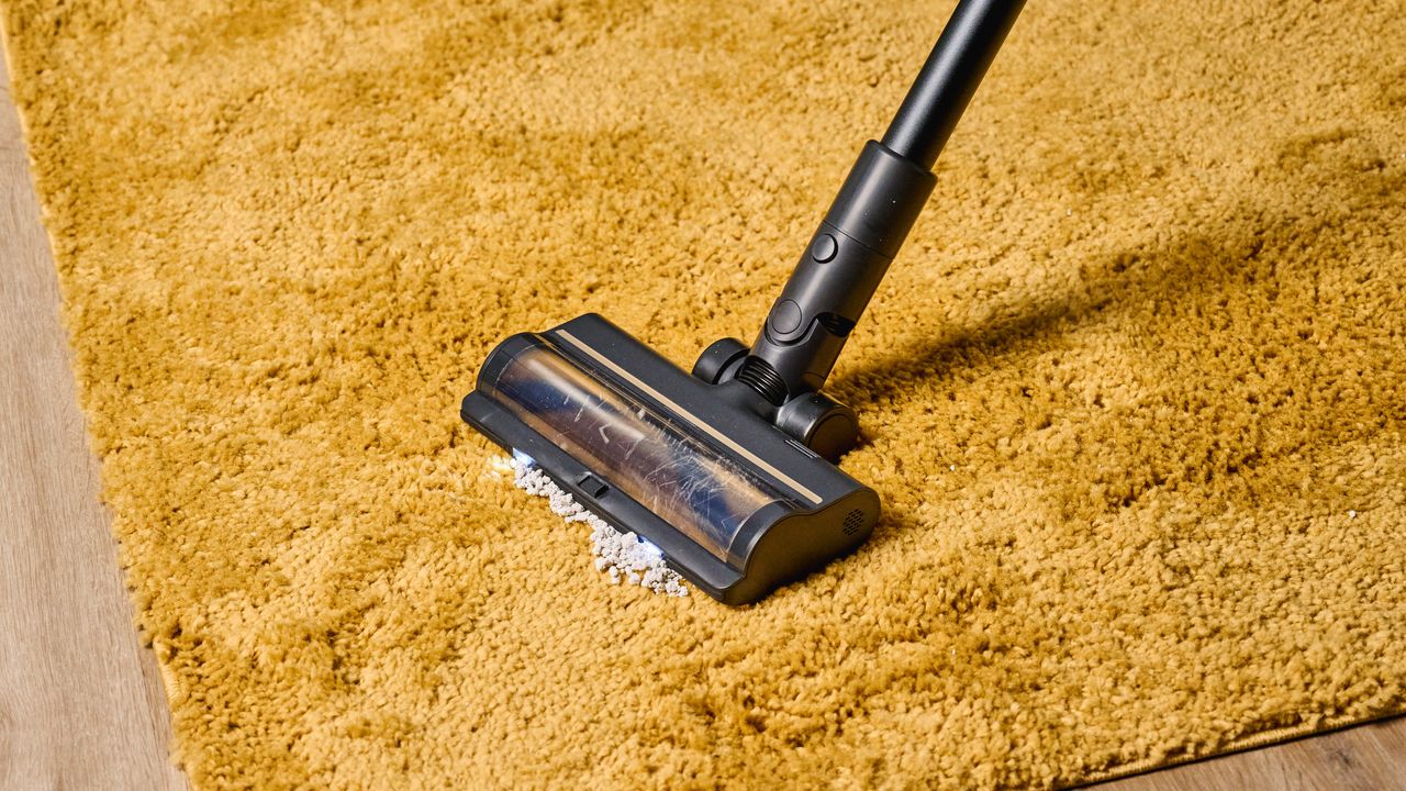 A black and gold Dreame R10 Pro cordless vacuum cleaner